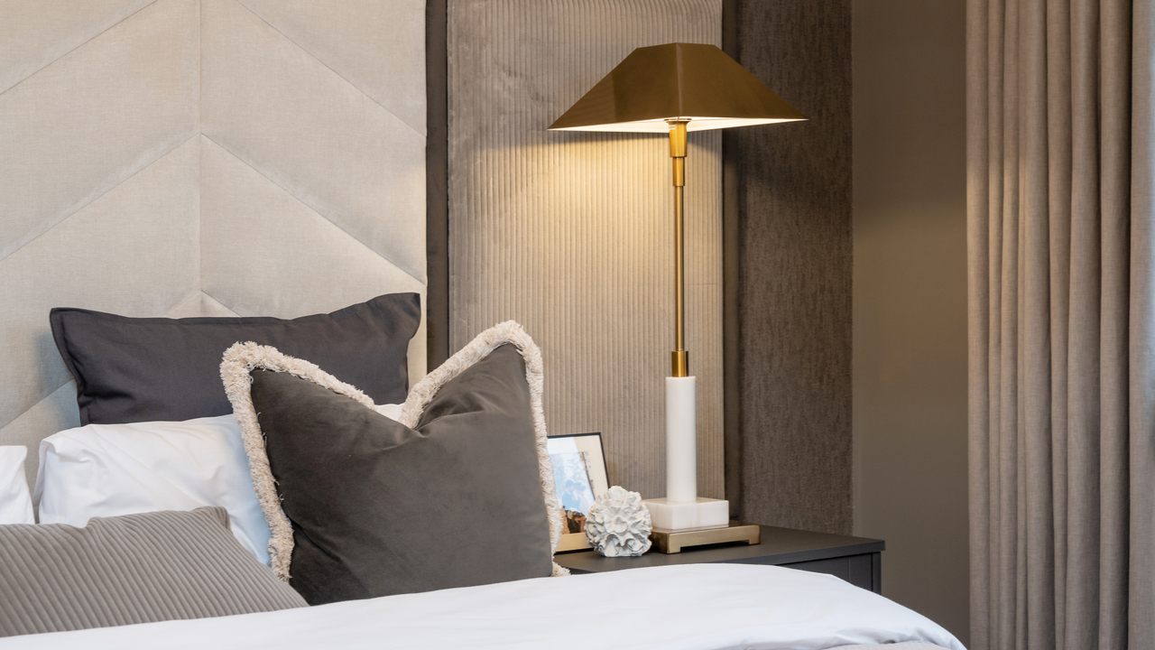 Bed with gold bedside lamp