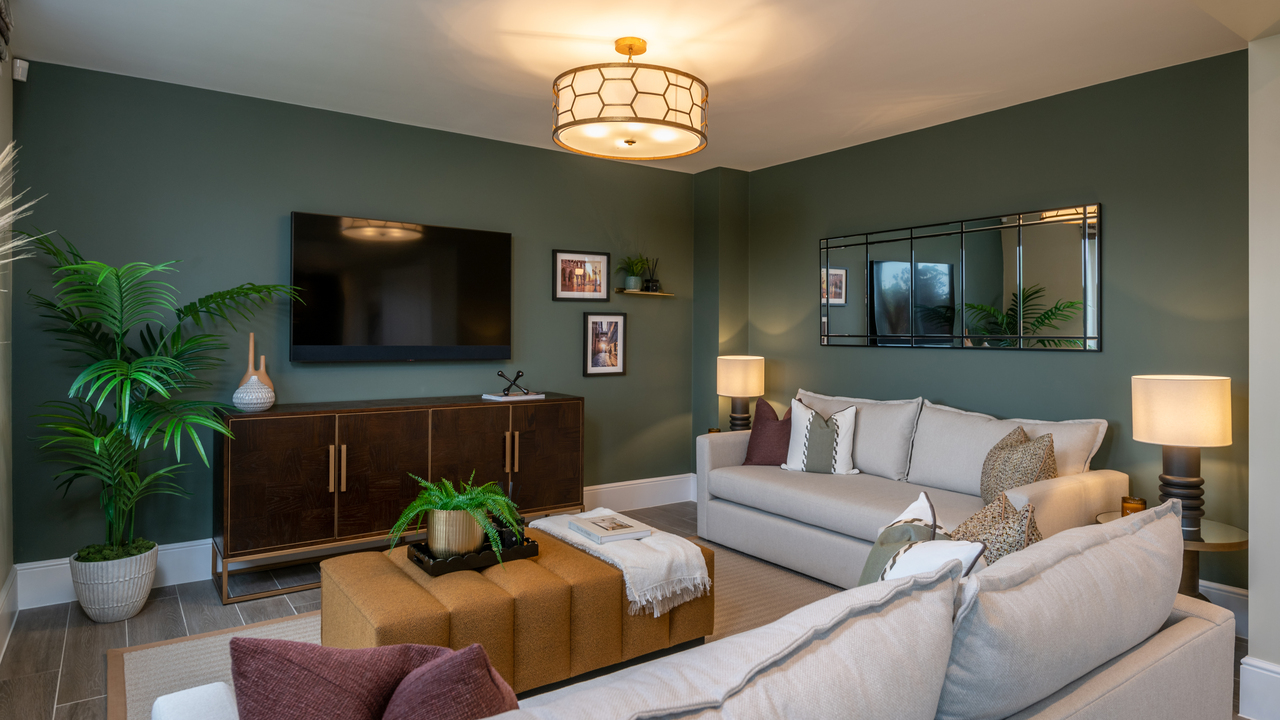 Family room with dark walls and cream sofas