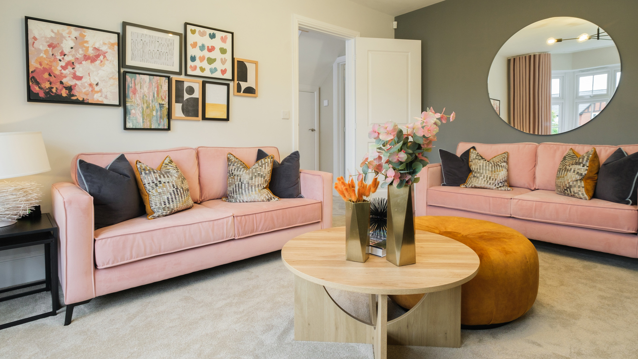 Lounge with pale pink sofas and ochre foot pouffe