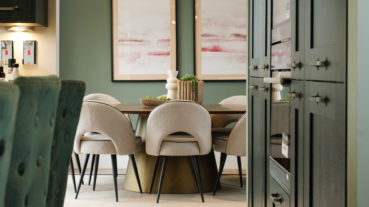 Dining area with green walls and large artworks