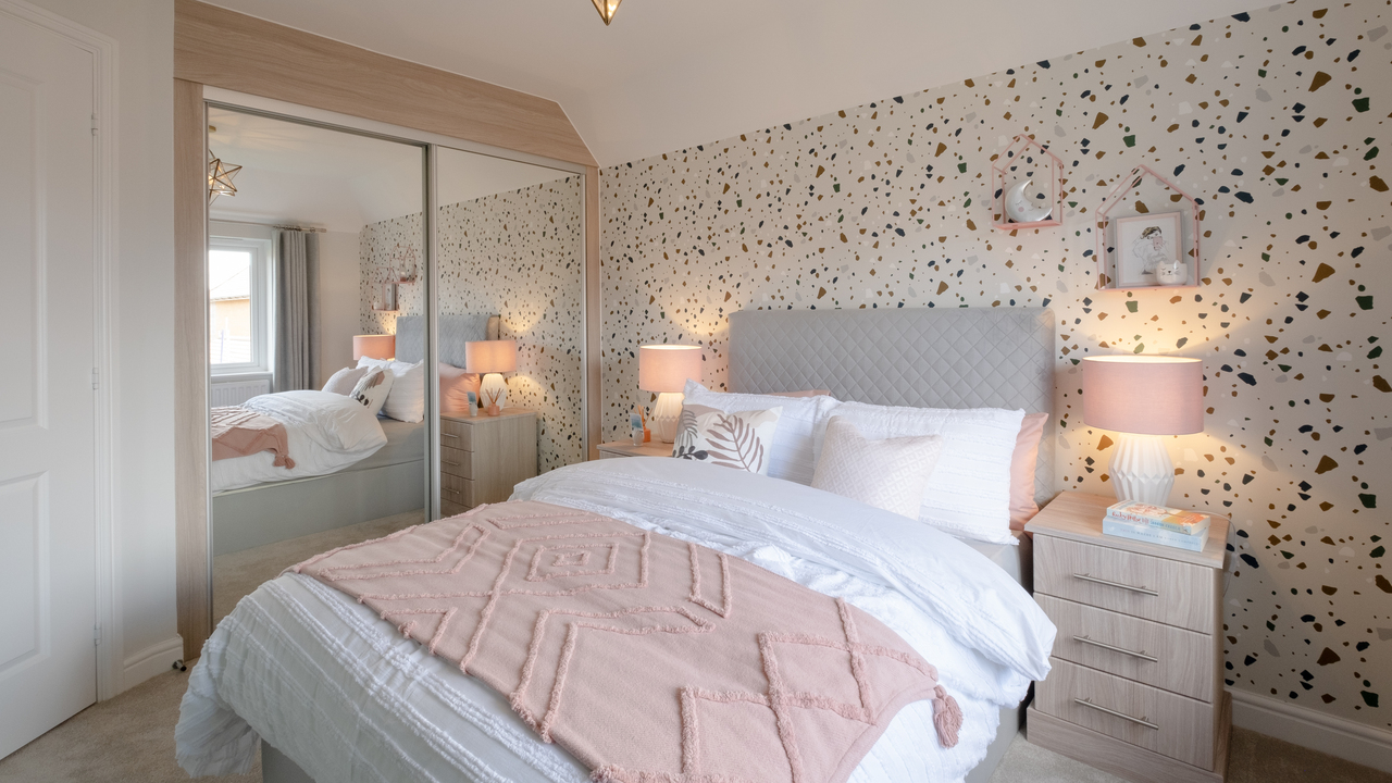 Bedroom with pink and grey colour scheme and mirrored wardrobe