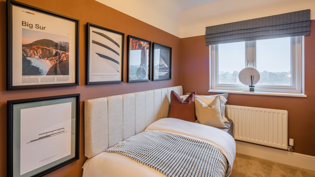 Single bedroom with a selection of framed graphic artworks