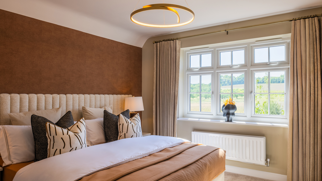 Bedroom in warm earthy tones with gold light
