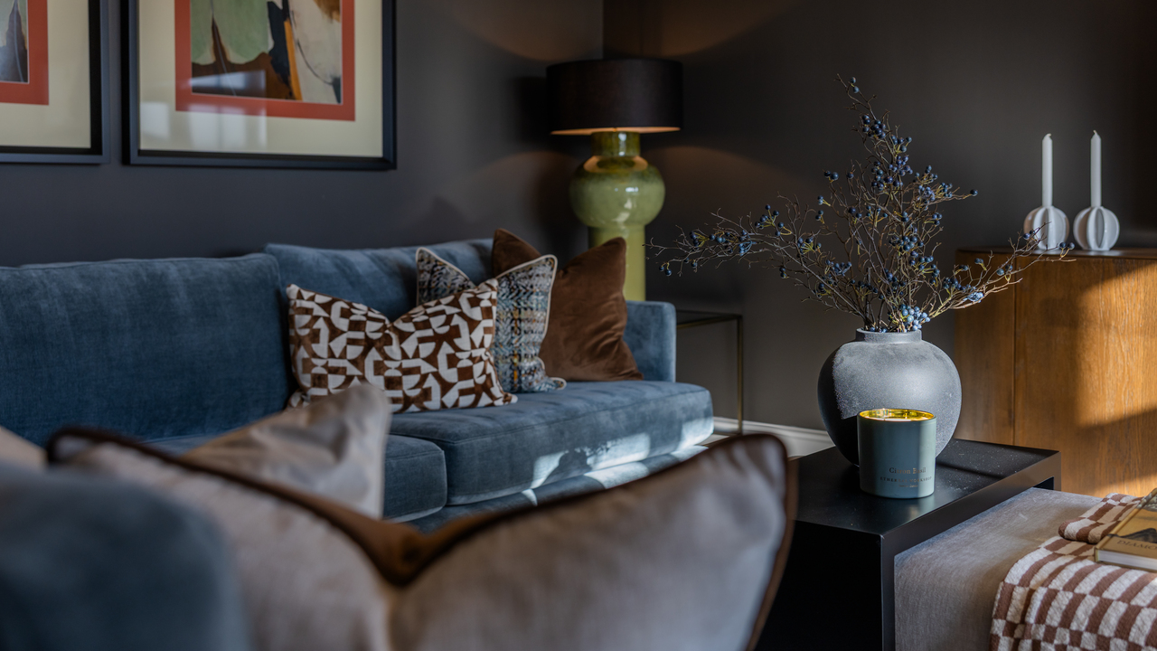 Blue velvet sofa and cosy home accessories