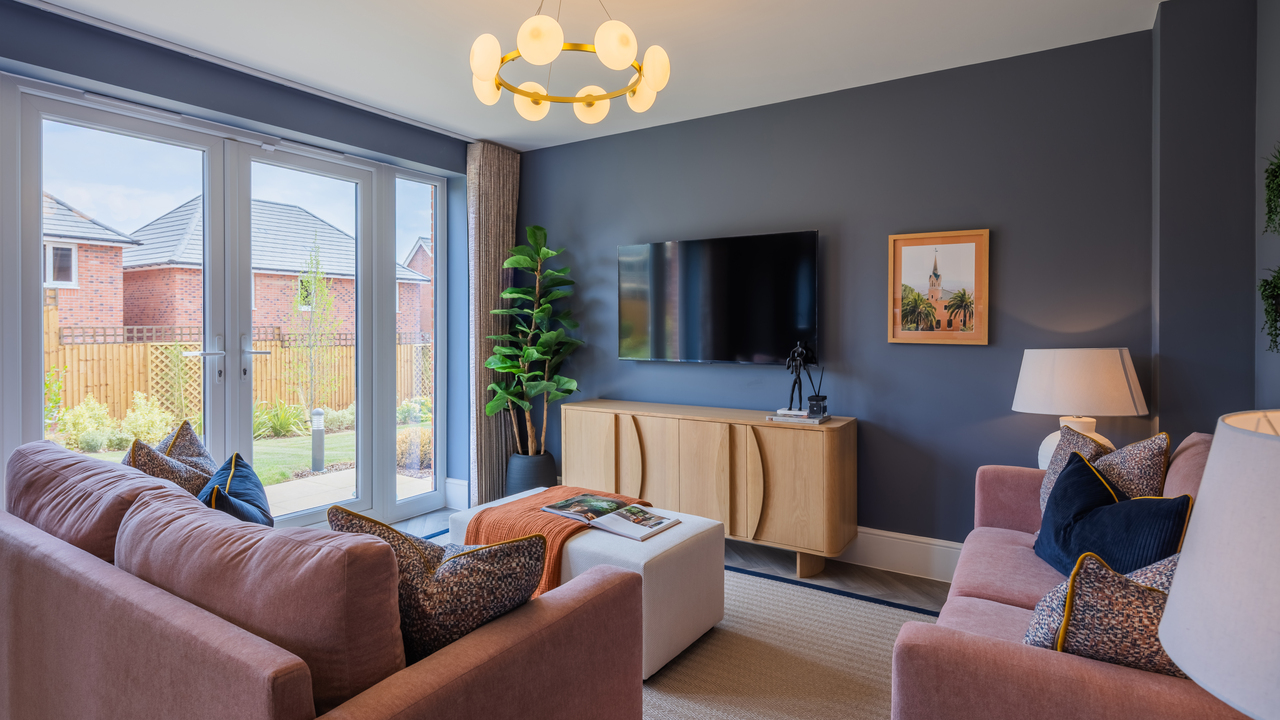 Family area with dark walls and patio doors leading to the garden