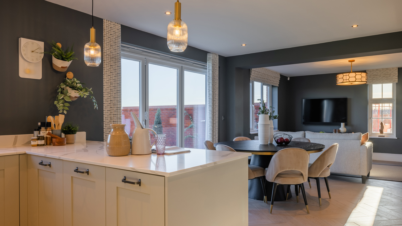 Modern kitchen and dining area with brass accessories