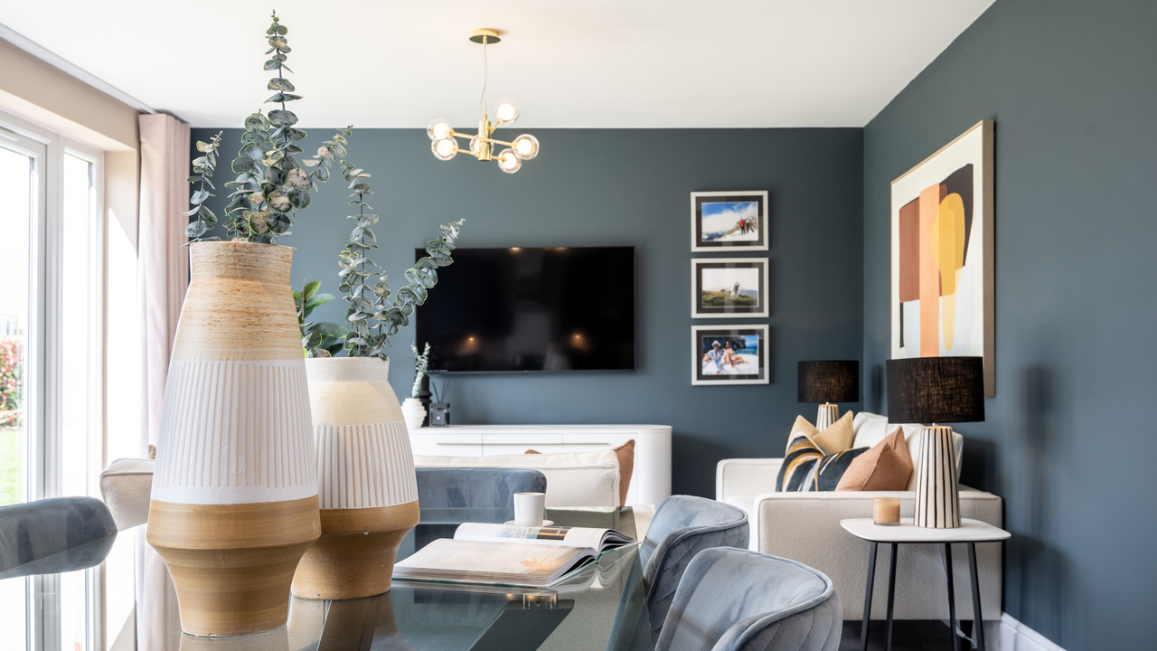 Dining table featuring two large vases full of eucalyptus leaves