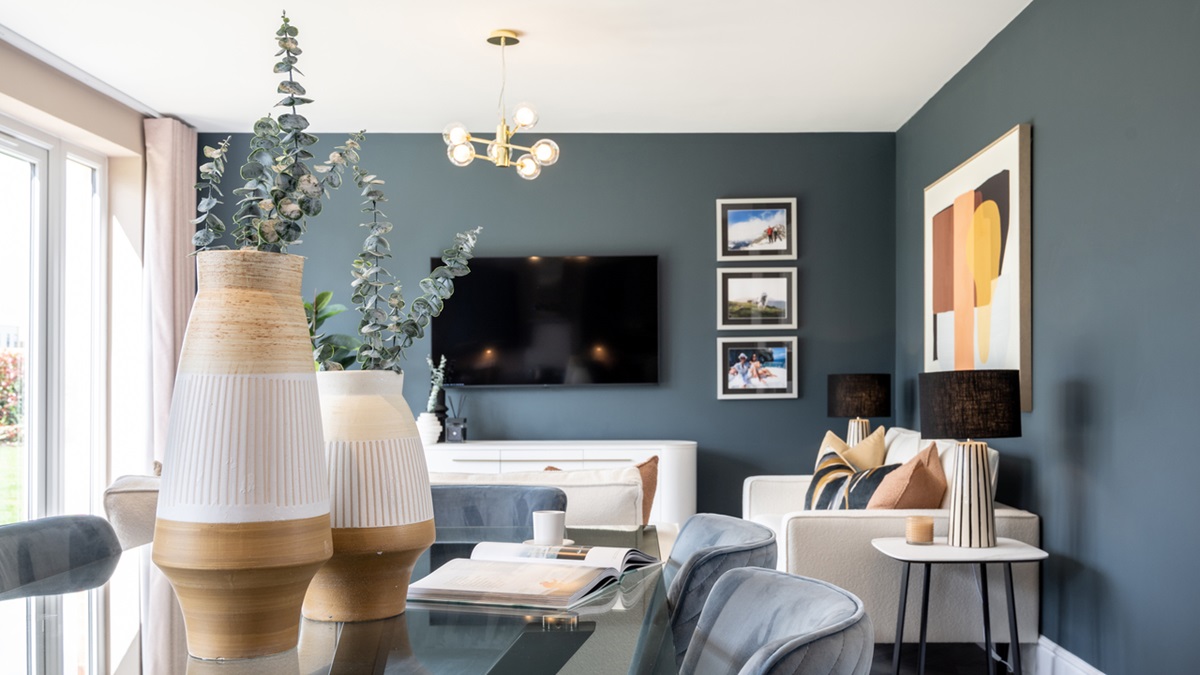 Dining table featuring two large vases full of eucalyptus leaves