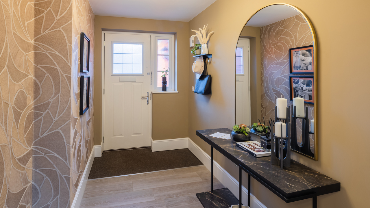 Stylish hallway with large gold archway mirror