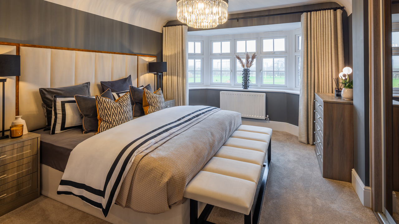 Hotel-style bedroom with chandelier and luxurious heavy curtains