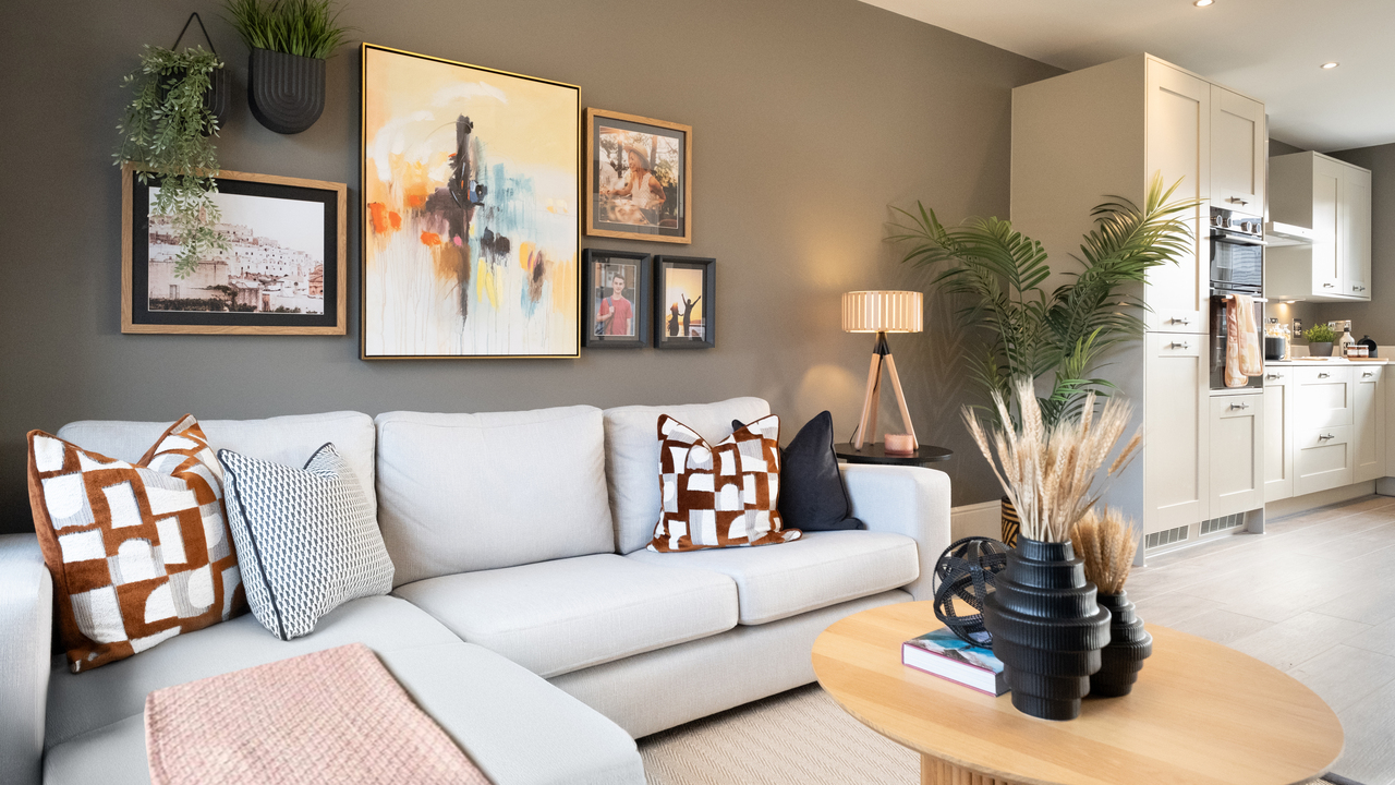 Family area with wooden coffee table and kitchen in the background