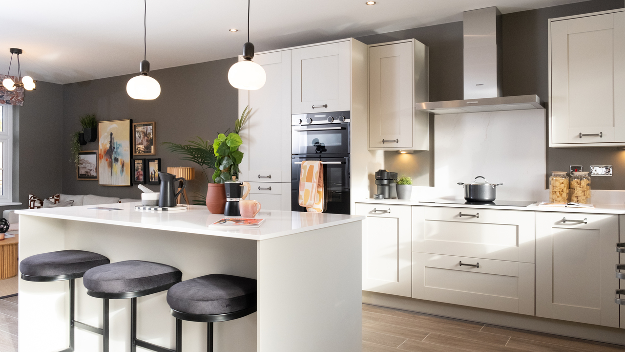 Contemporary kitchen with two pendant lights hanging over a breakfast bar
