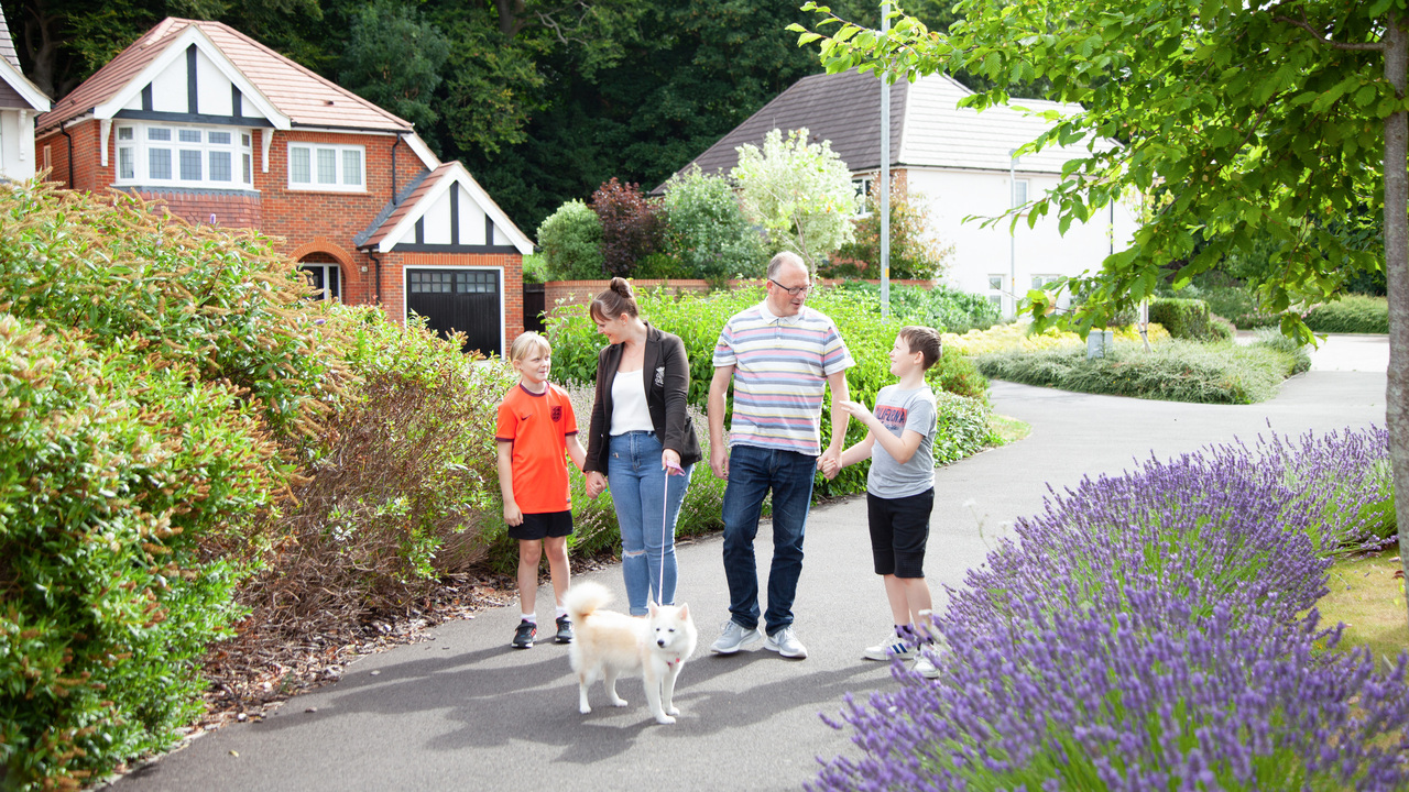 Family take dog for a walk a Redrow Development