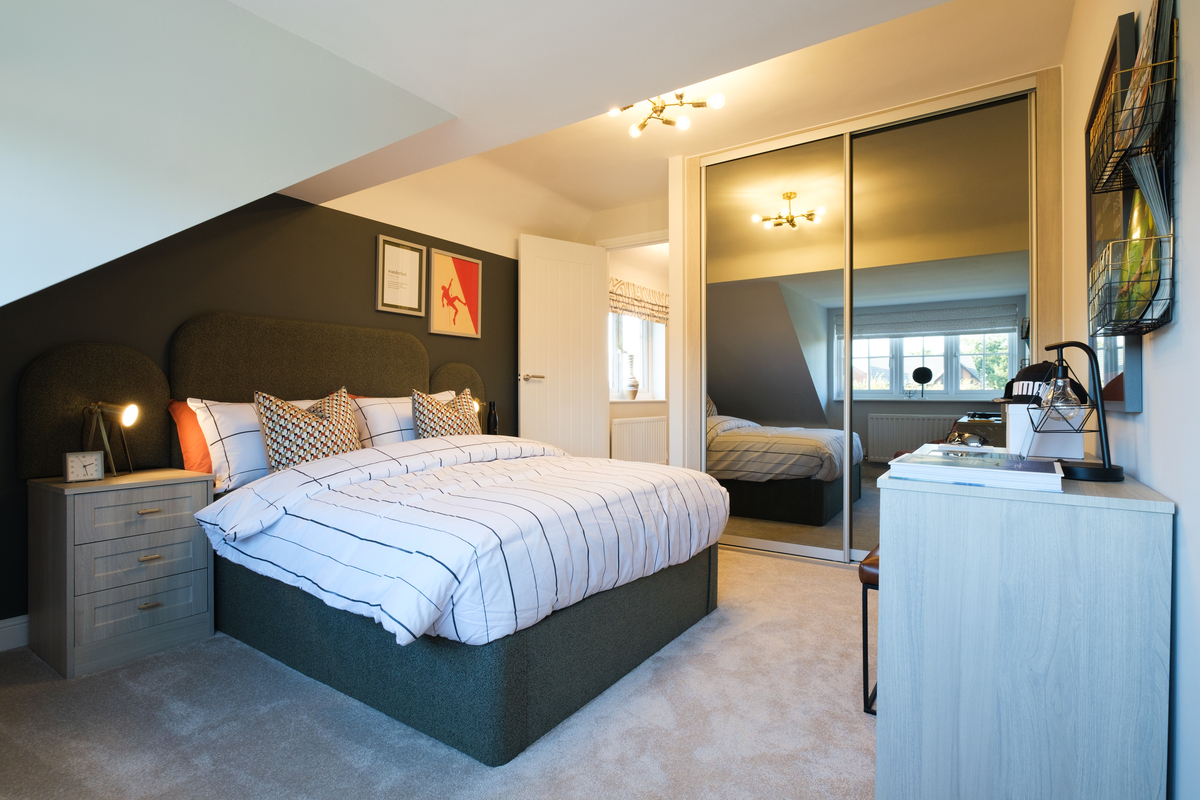 Bedroom with sloped ceiling and mirrored wardrobe