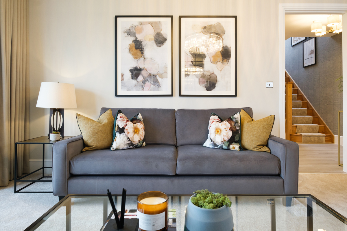 Blue sofa against a wall featuring two large abstract artworks