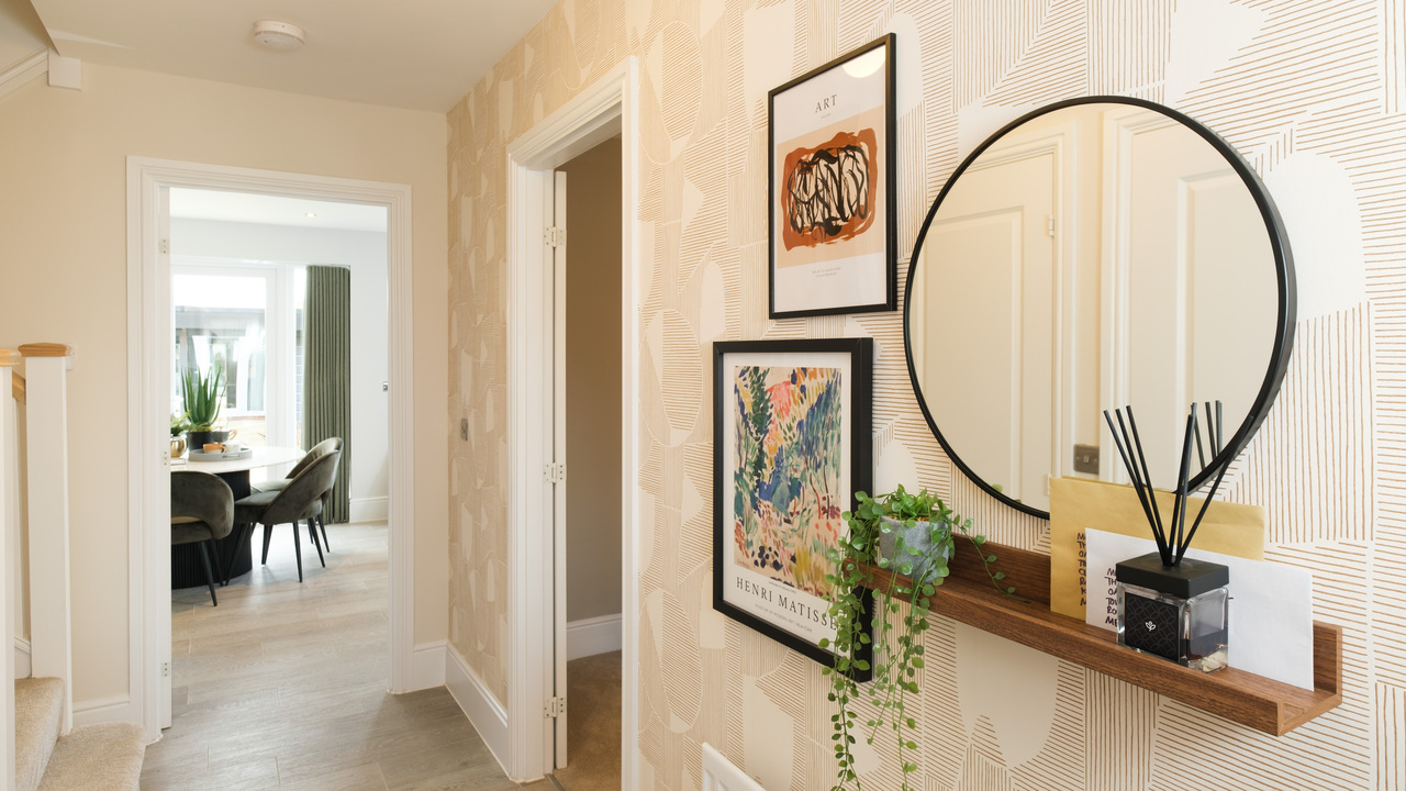 Hallway with round mirror and pictures on the wall