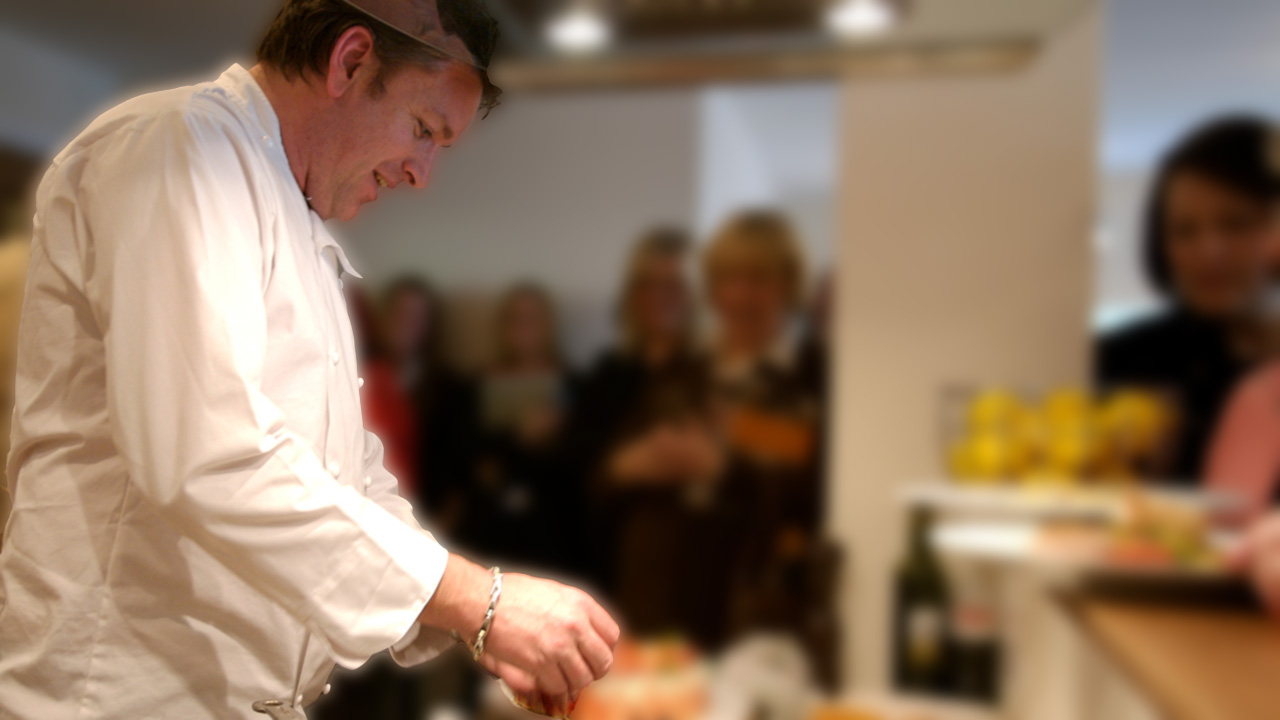 James Martin preparing food for an audience
