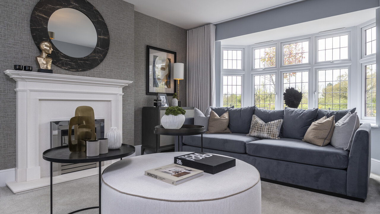 Grey lounge with large foot pouffe and coffee table