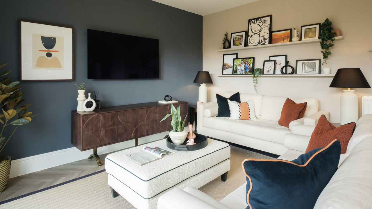 Lounge with navy feature wall and cream corner sofa