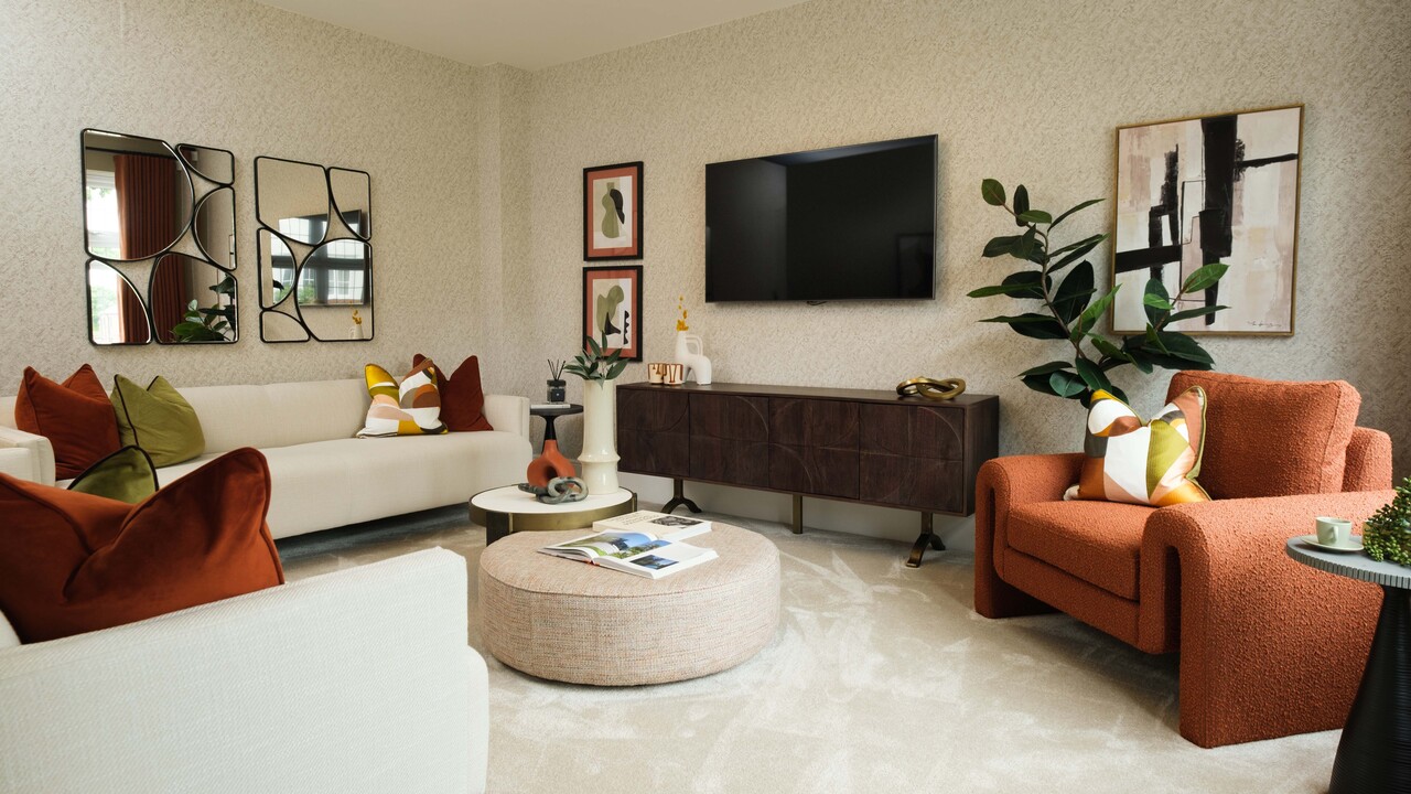 Lounge with uniquely shaped orange chair and large plants