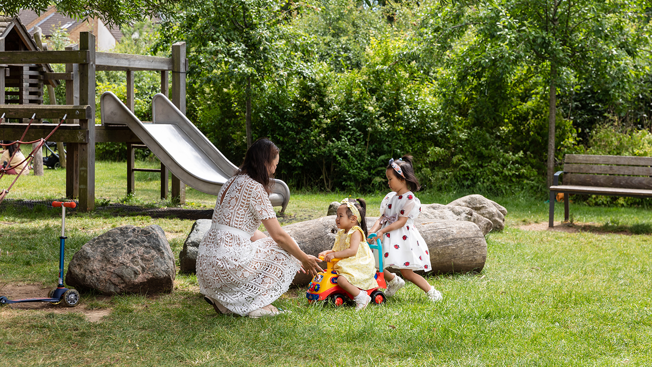 Mother and her two daughters playing in a park