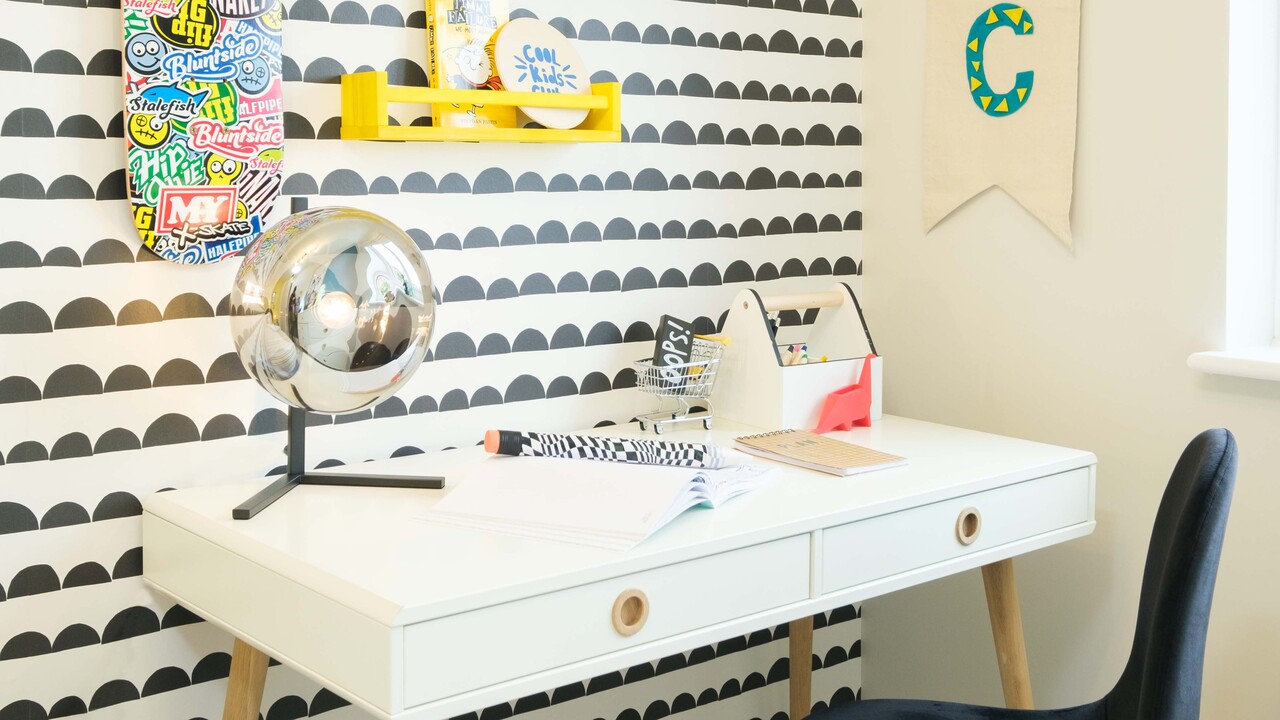 Desk against a wall with funky black and white wallpaper
