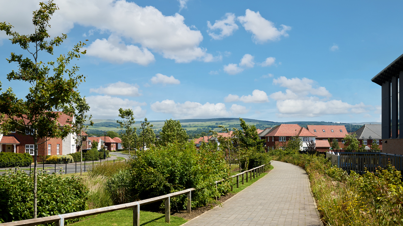 Path in Woodford Garden Village, with vast countryside visible in the background