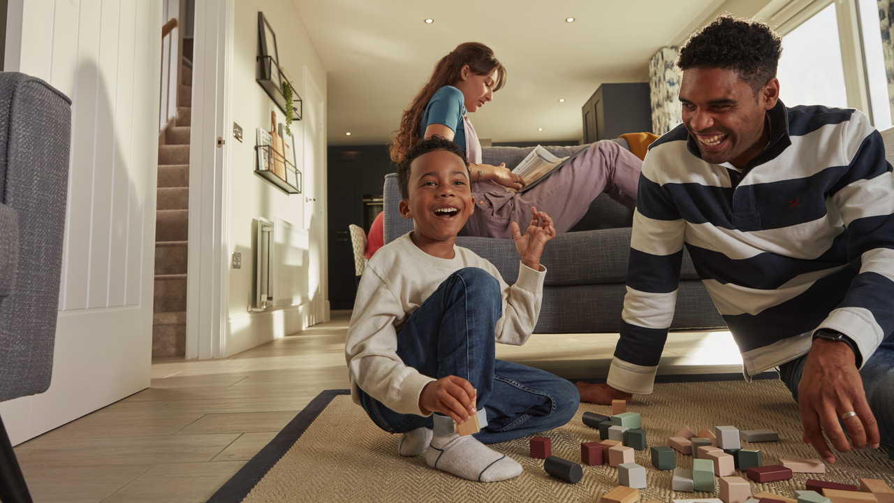 Father and child playing with blocks on the floor