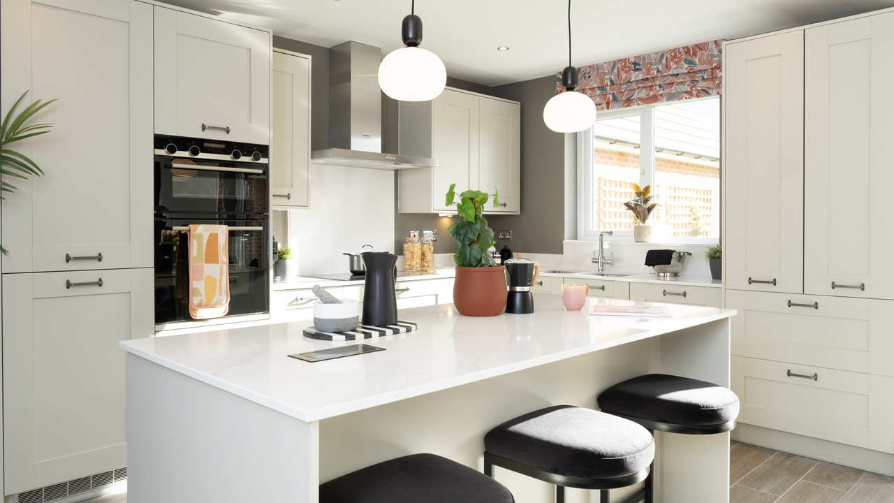 Light and airy kitchen with white units and worktops
