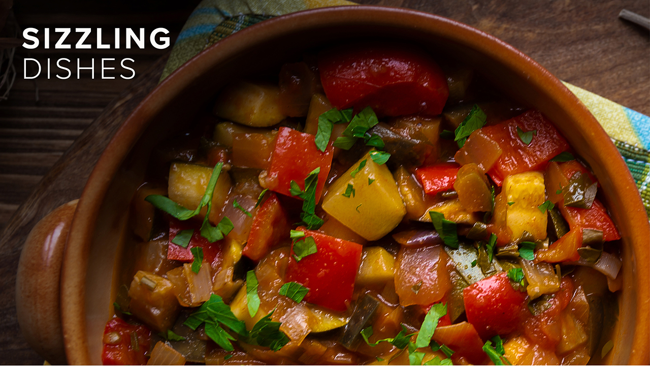 A warm pot of colourful food with "Sizzling Dishes" written over the top