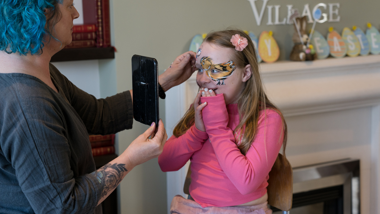 Girl having her face painted