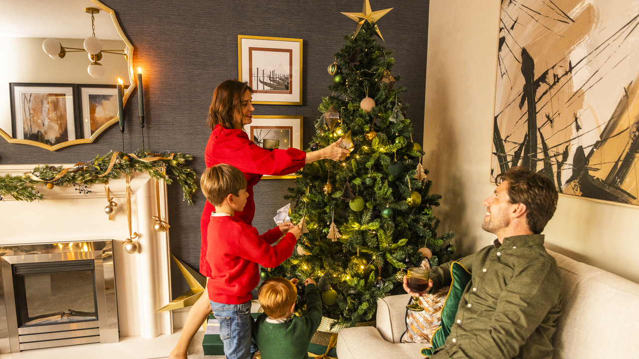 Family decorating the Christmas tree