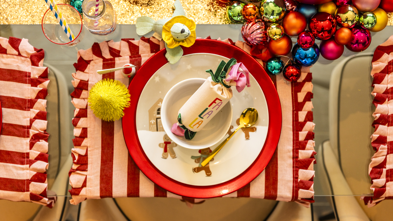 Circus themed Christmas table setting with pink and red striped placemat