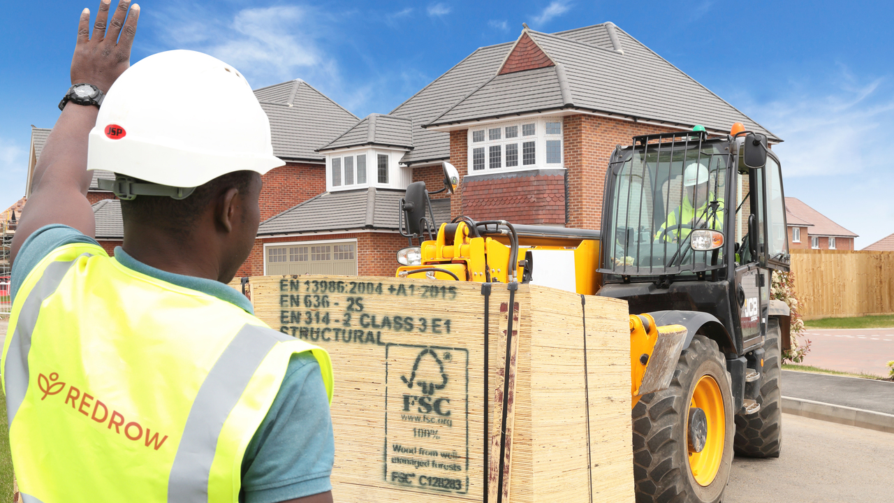Redrow construction worker moving FSC Timber