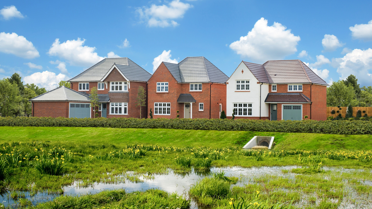 Redrow development situated by a meadow and a pond