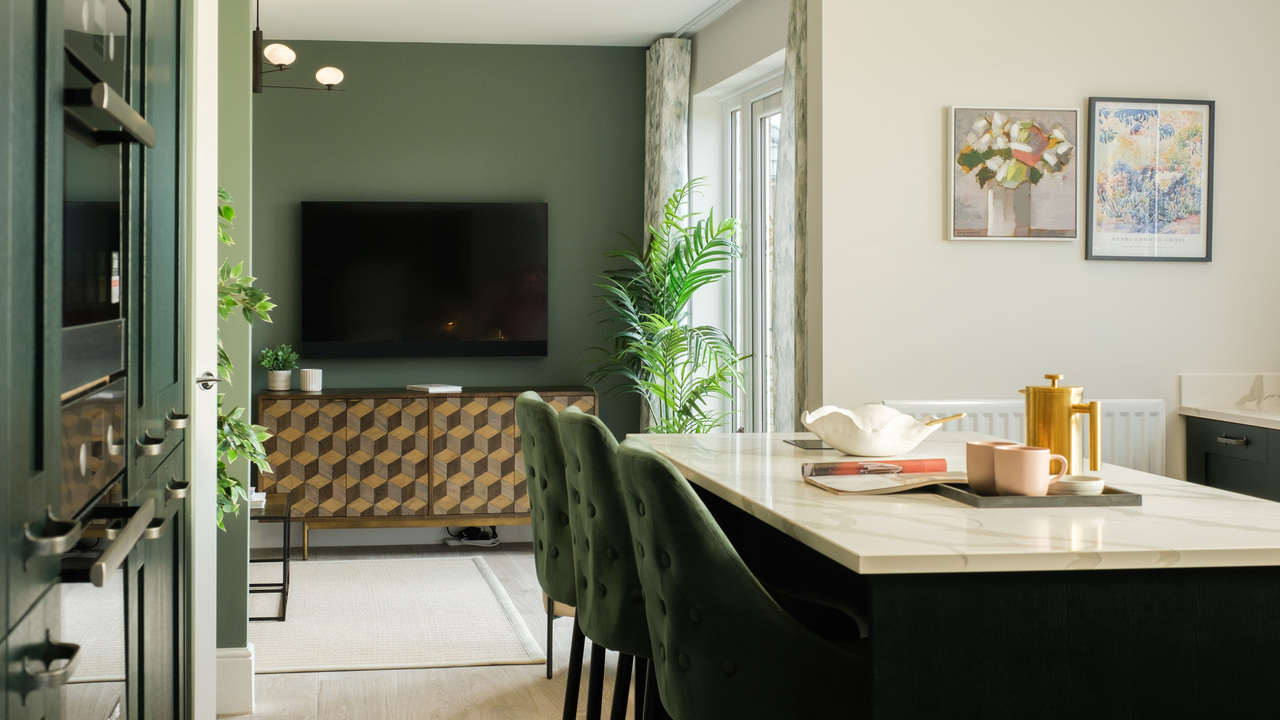 Open plan dining area leading to a family area with a wall-mounted television