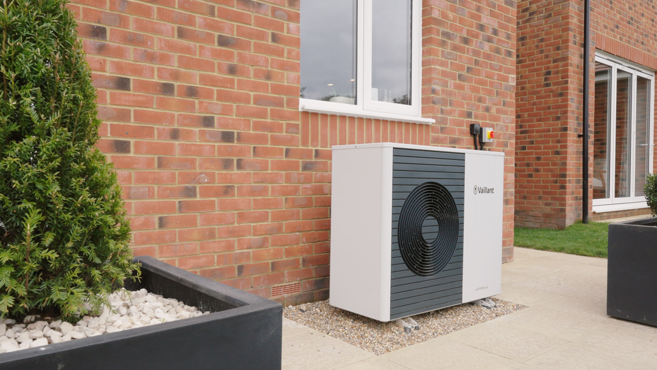 Air source heat pump in the garden of a Heritage home