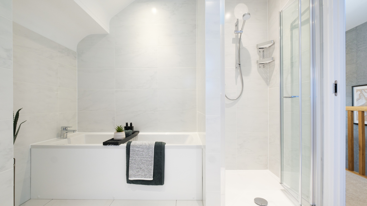White bathroom with both a bath and separate shower cubicle